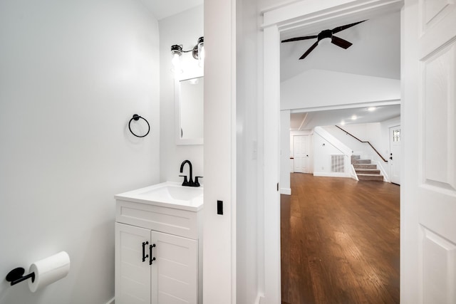 bathroom with vanity, vaulted ceiling, wood-type flooring, and ceiling fan