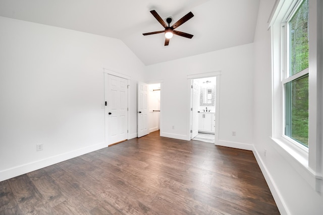 interior space featuring lofted ceiling, sink, ceiling fan, dark wood-type flooring, and ensuite bath