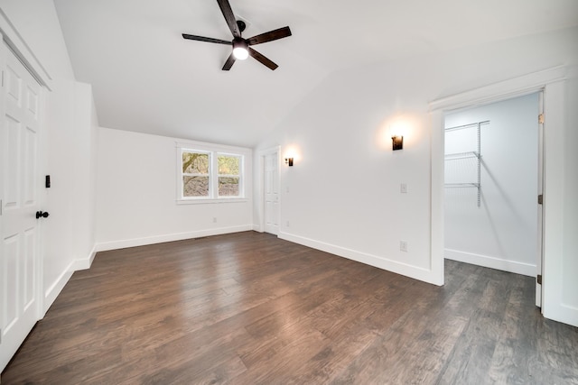 unfurnished room featuring ceiling fan, dark hardwood / wood-style flooring, and vaulted ceiling