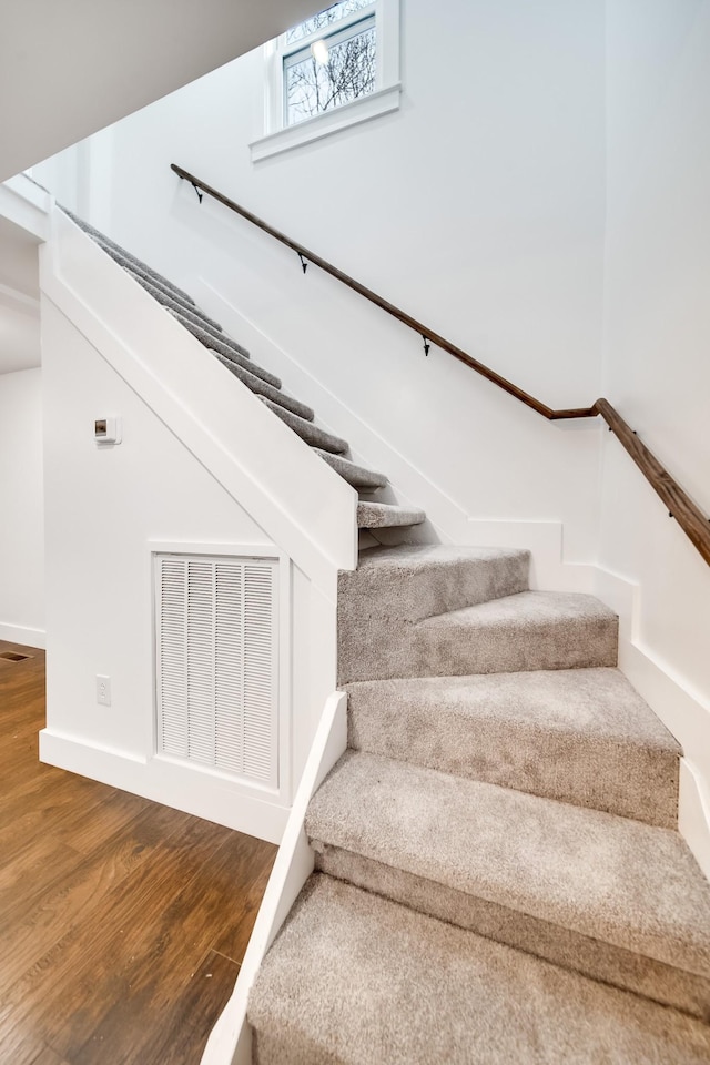 stairs featuring wood-type flooring