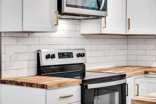 kitchen featuring white cabinetry, appliances with stainless steel finishes, butcher block counters, and tasteful backsplash