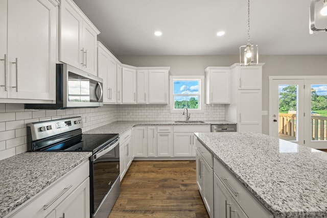 kitchen featuring white cabinets, stainless steel appliances, dark hardwood / wood-style flooring, and a healthy amount of sunlight