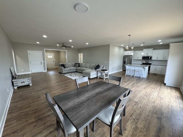 dining space featuring ceiling fan and dark hardwood / wood-style floors