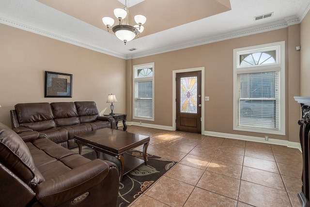 tiled living room featuring a healthy amount of sunlight, crown molding, and an inviting chandelier