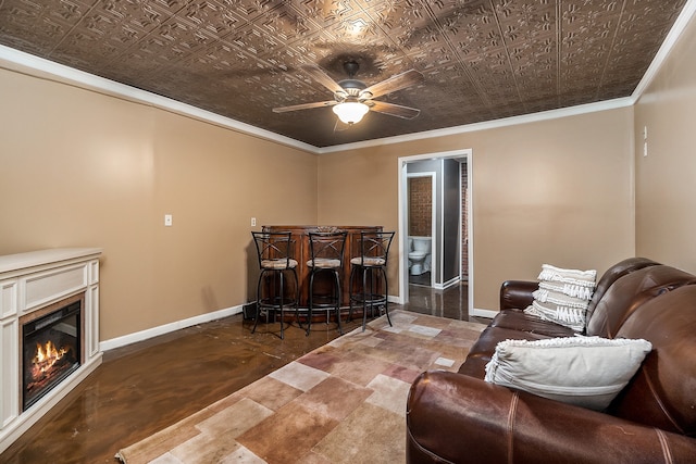 living room featuring tile patterned floors, crown molding, and ceiling fan