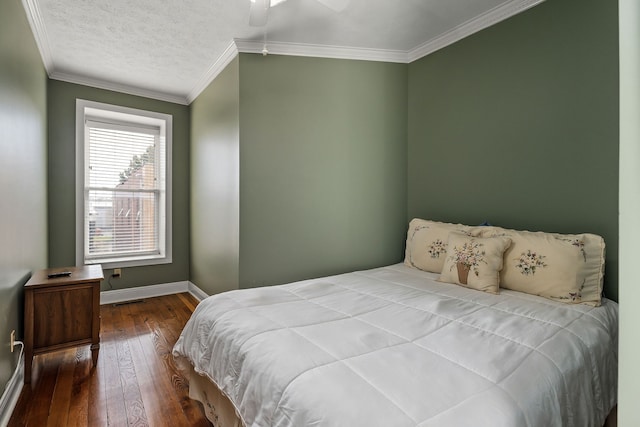 bedroom featuring a textured ceiling, crown molding, hardwood / wood-style floors, and ceiling fan