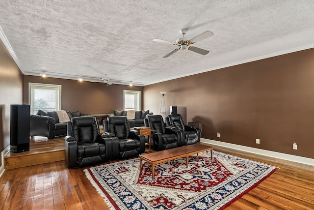 home theater with ceiling fan, crown molding, hardwood / wood-style floors, a textured ceiling, and track lighting