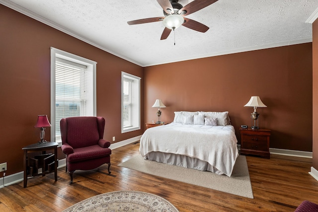 bedroom featuring ornamental molding, a textured ceiling, ceiling fan, and hardwood / wood-style floors