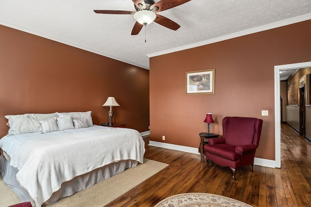 bedroom featuring a textured ceiling, crown molding, hardwood / wood-style floors, and ceiling fan