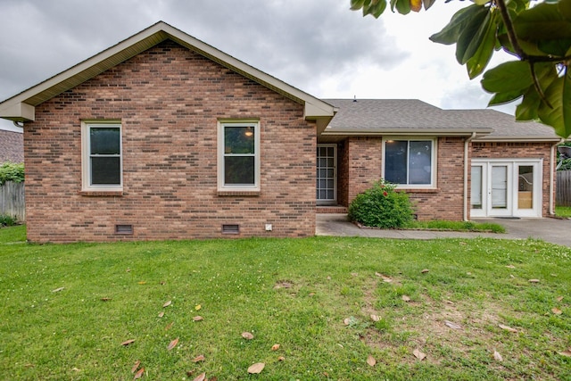 single story home with crawl space, roof with shingles, a front lawn, and brick siding