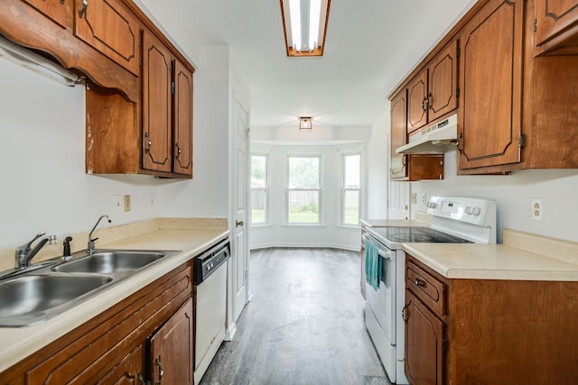 kitchen with light wood-type flooring, sink, and white appliances