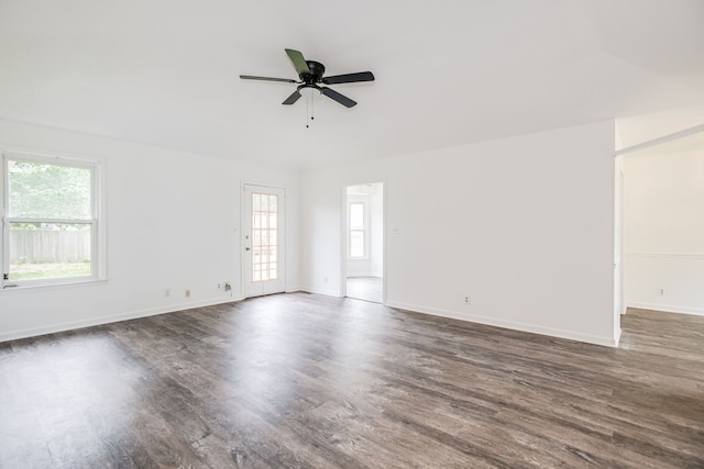 empty room with ceiling fan and dark hardwood / wood-style floors