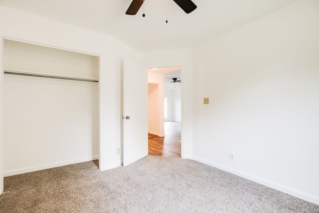 unfurnished bedroom with carpet flooring, ceiling fan, and a closet