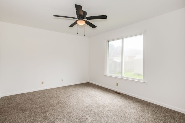 carpeted empty room featuring plenty of natural light and ceiling fan