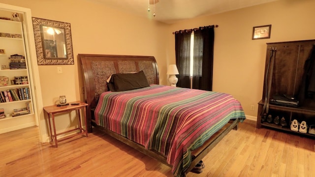 bedroom featuring light wood-style floors and baseboards