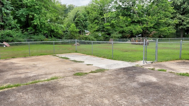 view of yard with a patio, fence, and a gate