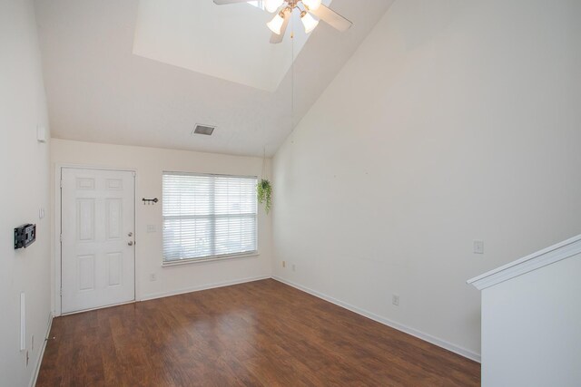 empty room with ceiling fan, lofted ceiling, and wood-type flooring