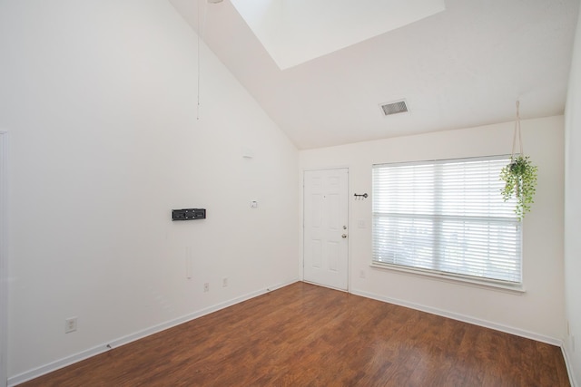 unfurnished room with vaulted ceiling and hardwood / wood-style flooring