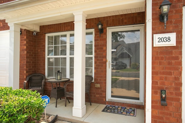 view of exterior entry featuring a porch