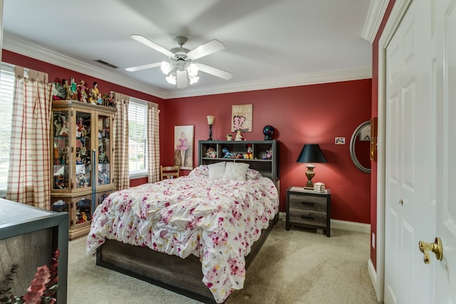 carpeted bedroom featuring a closet, ceiling fan, and crown molding