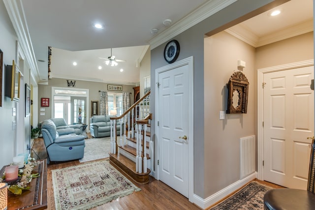 foyer featuring ornamental molding, french doors, hardwood / wood-style floors, and ceiling fan