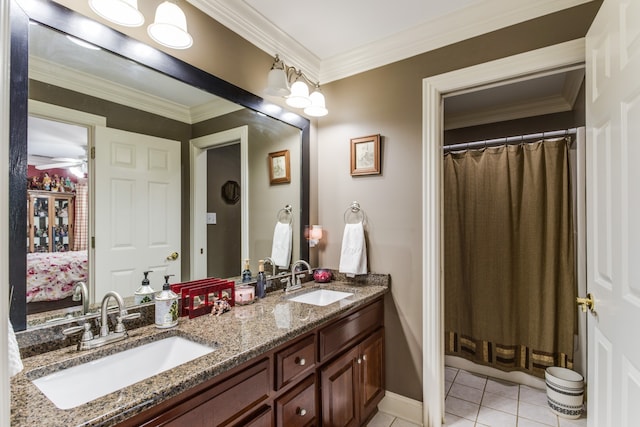 bathroom with ornamental molding, dual bowl vanity, and tile patterned floors