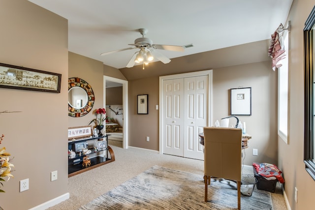 sitting room with carpet floors and ceiling fan