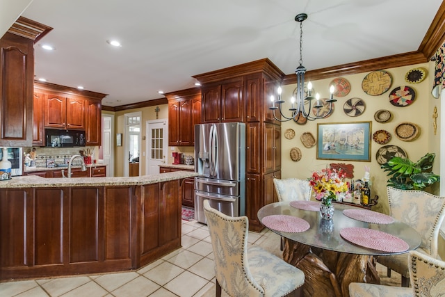 kitchen featuring light tile patterned flooring, pendant lighting, ornamental molding, and stainless steel refrigerator with ice dispenser