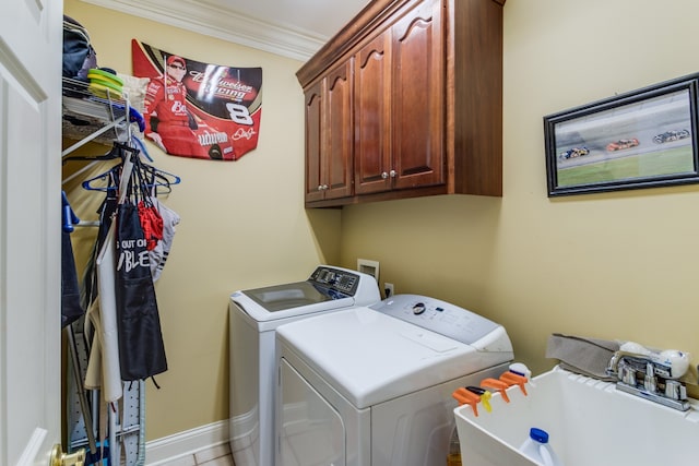 washroom featuring washing machine and clothes dryer, sink, cabinets, tile patterned floors, and ornamental molding