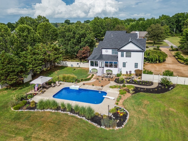 view of pool featuring a diving board, a patio, and a lawn