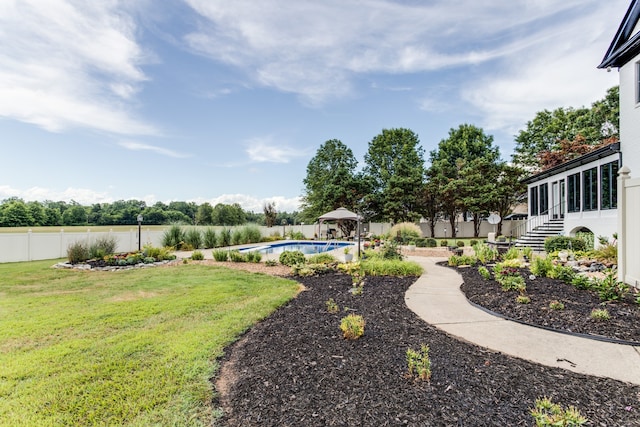 view of yard with a fenced in pool