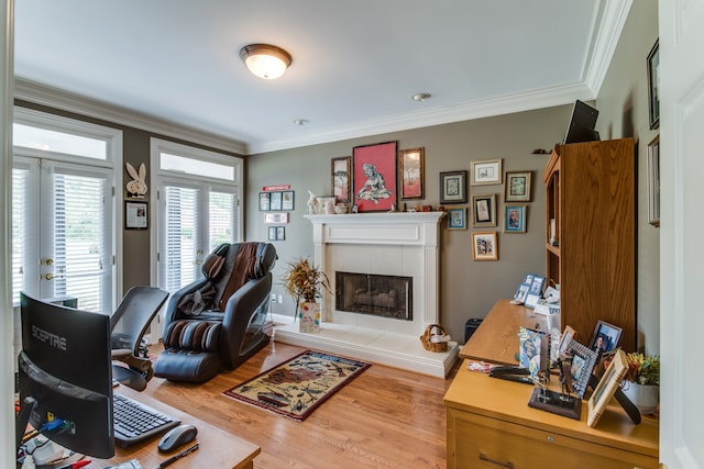 living room with a fireplace, crown molding, and wood-type flooring