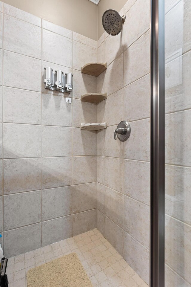 bathroom with a tile shower