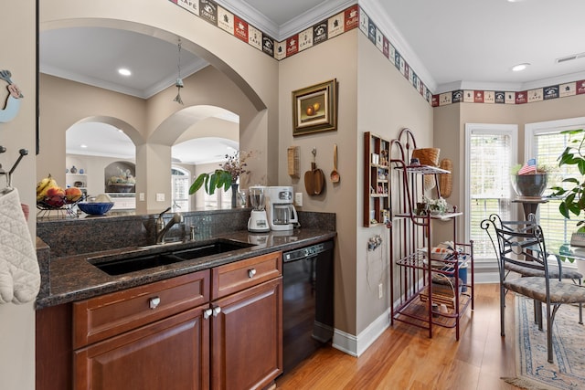 kitchen featuring dark stone counters, light hardwood / wood-style flooring, sink, dishwasher, and ornamental molding