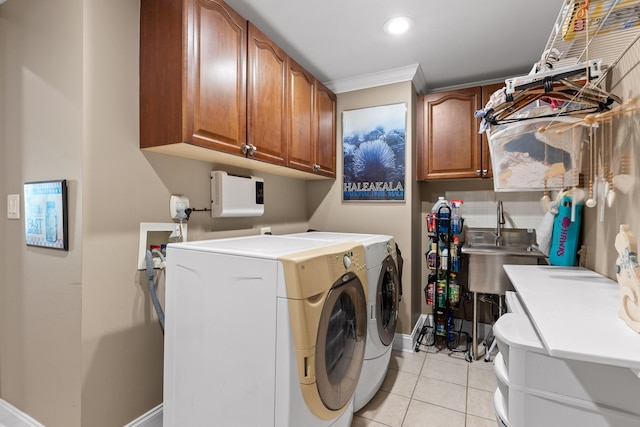 clothes washing area featuring sink, cabinets, light tile patterned floors, and independent washer and dryer