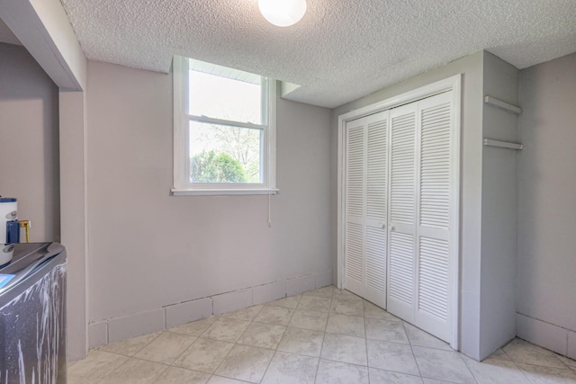 unfurnished bedroom with a textured ceiling and a closet