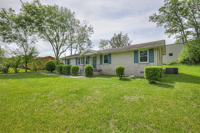 ranch-style home with a front yard and brick siding