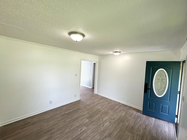 interior space with dark wood-style floors, crown molding, baseboards, and a textured ceiling