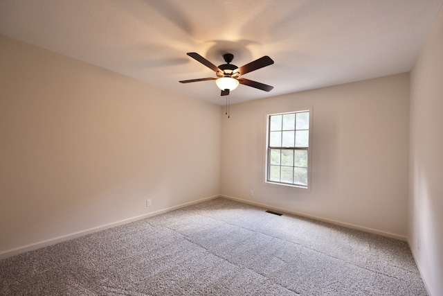 carpeted spare room with ceiling fan