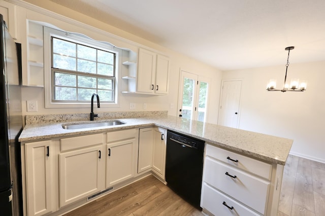 kitchen with sink, white cabinetry, decorative light fixtures, kitchen peninsula, and black appliances