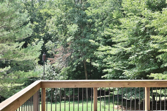 wooden deck featuring a yard