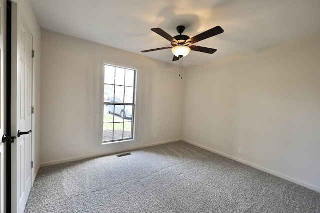 carpeted empty room featuring ceiling fan