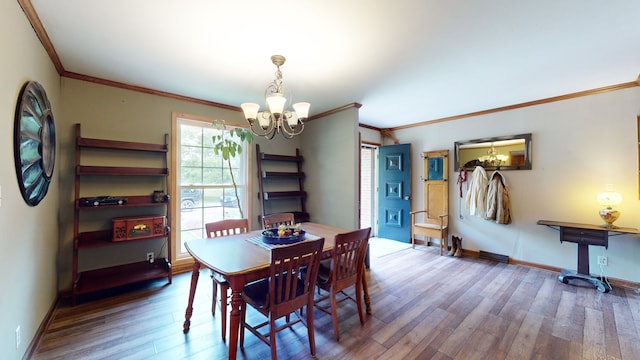 dining area with crown molding, a notable chandelier, and hardwood / wood-style floors