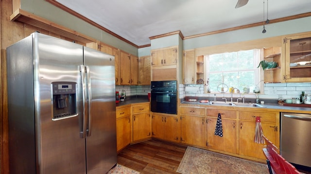 kitchen featuring appliances with stainless steel finishes, sink, decorative backsplash, dark hardwood / wood-style floors, and ceiling fan