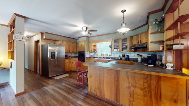 kitchen featuring tasteful backsplash, stainless steel appliances, tile counters, kitchen peninsula, and dark wood-type flooring