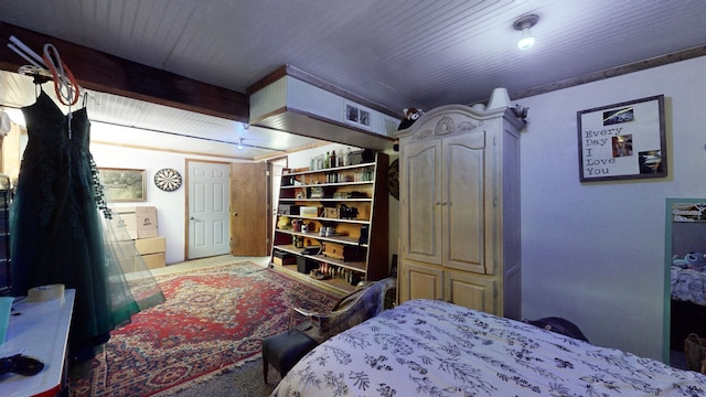 bedroom with carpet flooring and beam ceiling