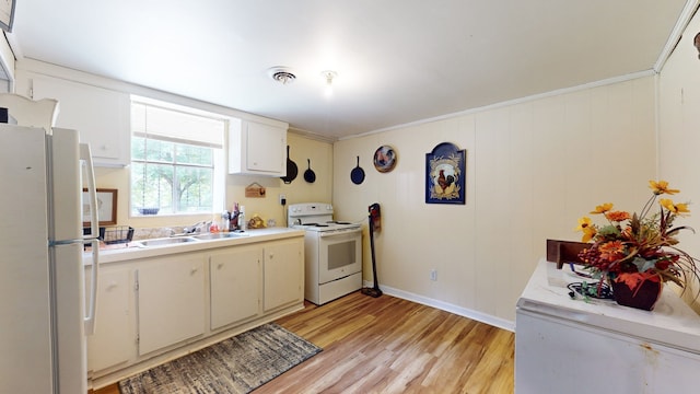 kitchen with white cabinets, white appliances, ornamental molding, sink, and light hardwood / wood-style floors