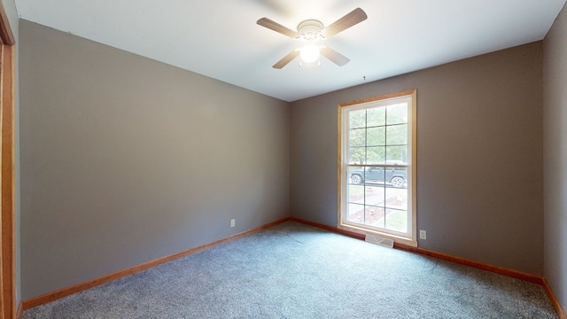 spare room with carpet flooring and ceiling fan