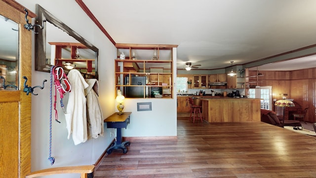 living room featuring ceiling fan, hardwood / wood-style floors, and crown molding