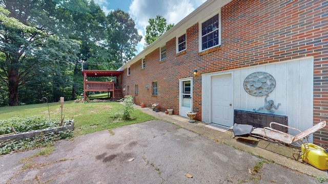 view of home's exterior with a deck and a lawn